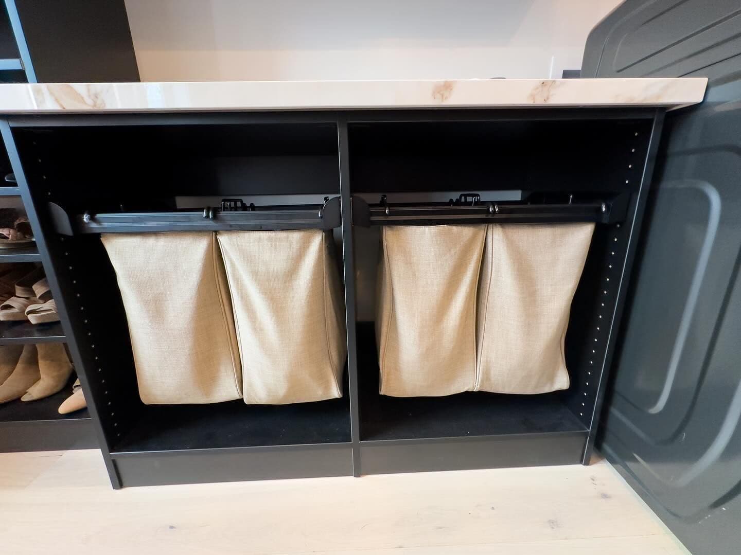 Laundry room with slide-out hampers and quartz counter