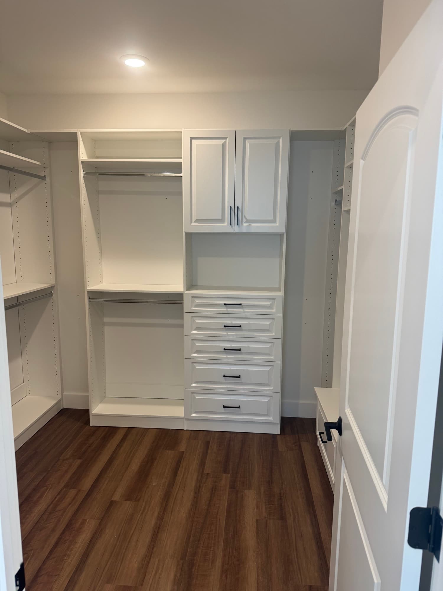 Custom mudroom with cubbies, bench, and upper cabinets